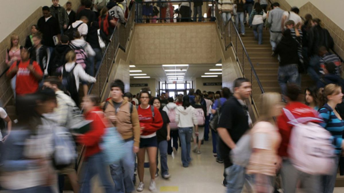 high school students stream through a crowded hallway