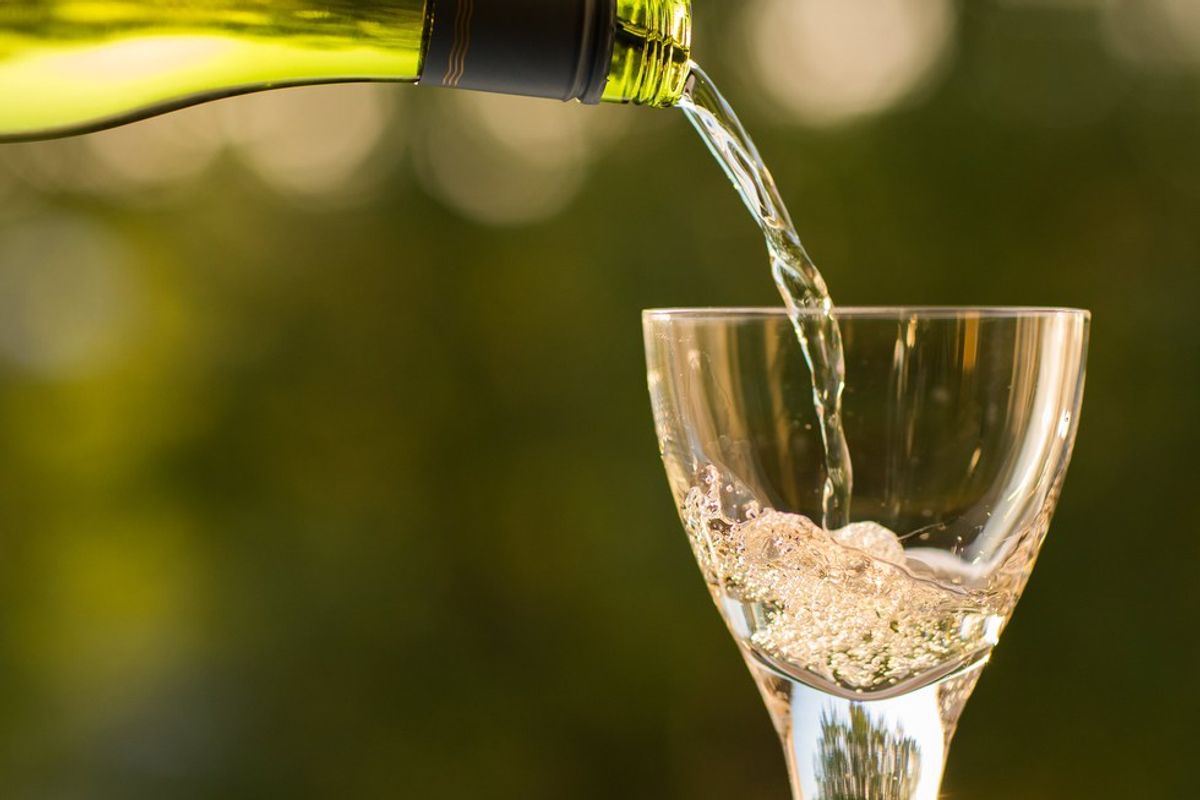 White wine being poured into a glass