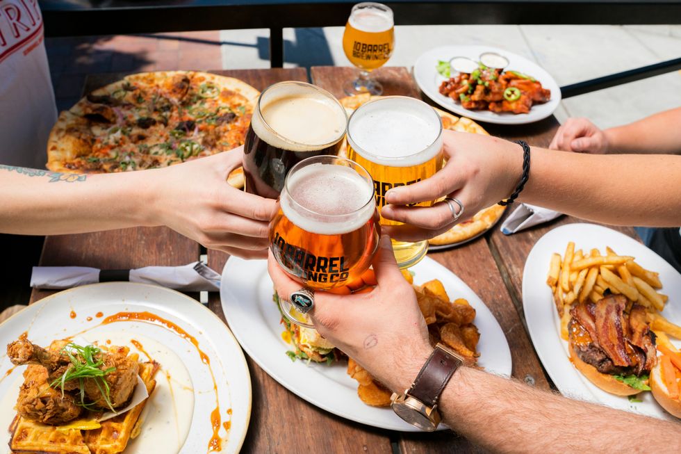 friends celebrate international beer day with alcoholic beverages