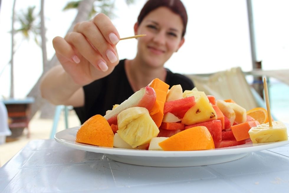 girl eating fruit salad