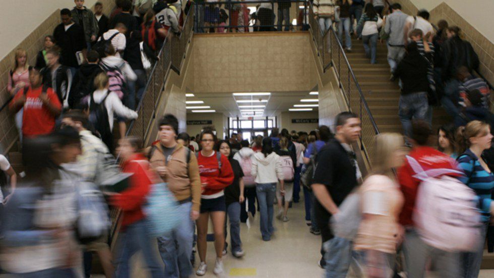 high school students stream through a crowded hallway