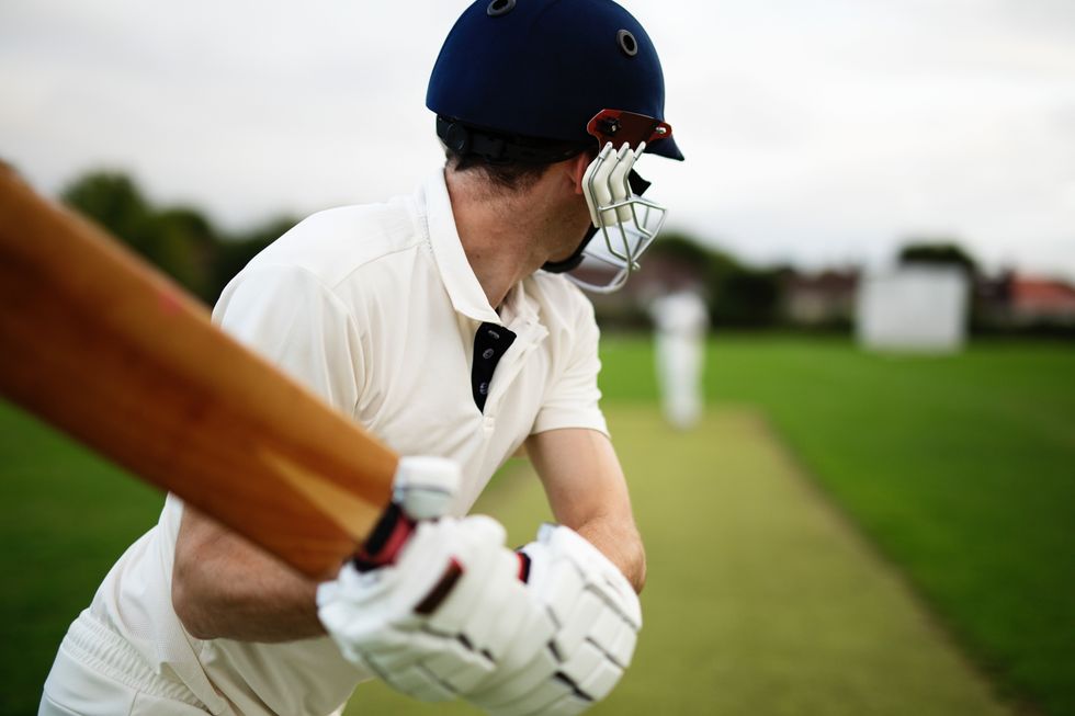 man holding cricket bat