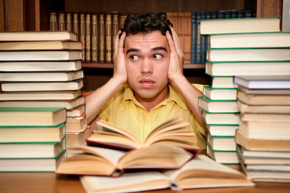 Student at the library with lots of books